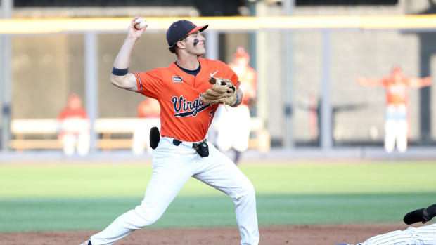 Henry Godbout throws to first on a double play during the Virginia baseball game against East Carolina in the Charlottesville Regional Final at the 2023 NCAA Baseball Tournament.